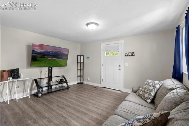a bedroom with furniture and a flat screen tv