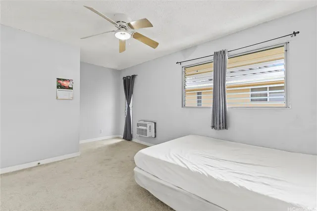 a bedroom with a bed next to a window