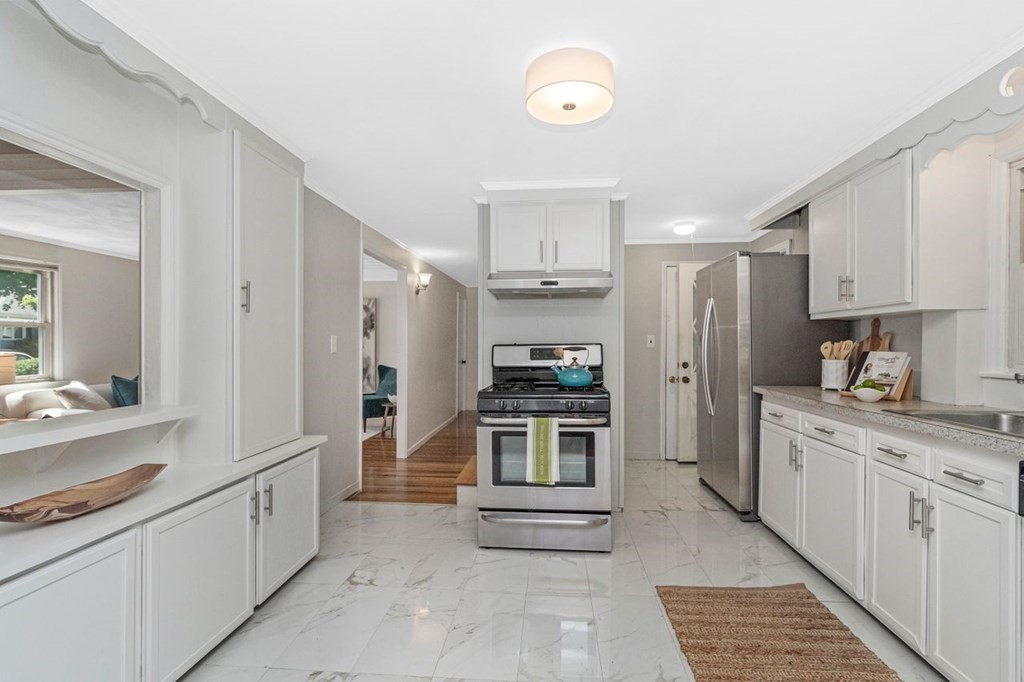61 Truman Road Newton, MA 02459 - Photo 12 of 28 a kitchen with stainless steel appliances a stove sink and refrigerator
