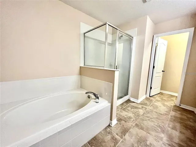 a bathroom with a bathtub and a shower