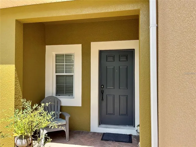 a front view of a house with a potted plant
