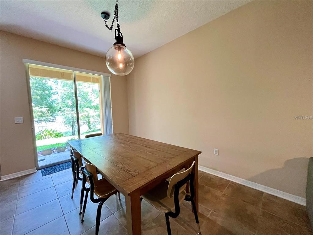 5552 Rutherford Place Oviedo, FL 32765 - Photo 5 of 20 a view of a dining room with furniture window and wooden floor