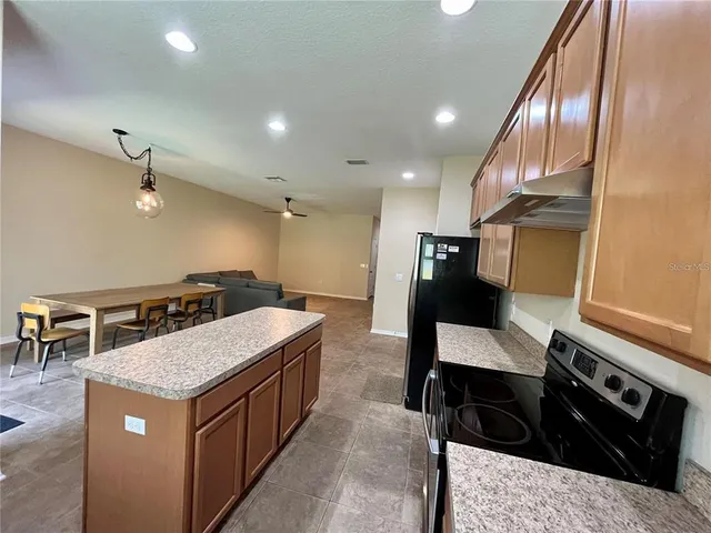 a kitchen with a stove and a refrigerator