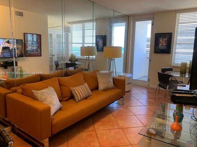 100 Lincoln Road, Unit 1129 Miami Beach, FL 33139 - Photo 1 of 31 a living room with furniture a flat screen tv and a window