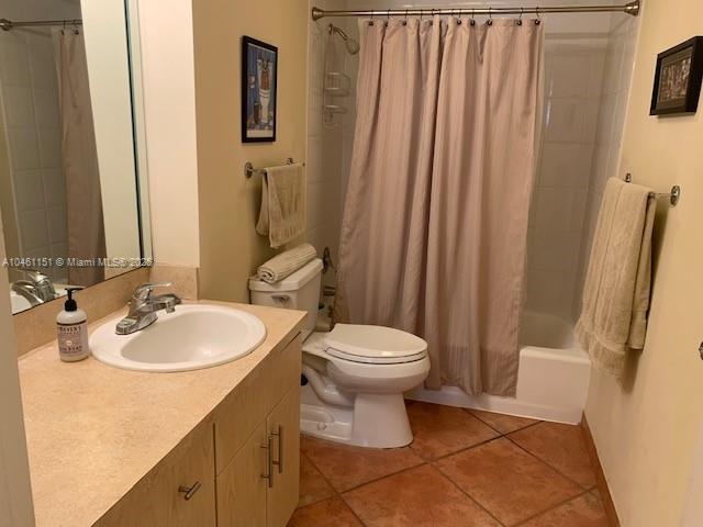 100 Lincoln Road, Unit 1129 Miami Beach, FL 33139 - Photo 12 of 31 a bathroom with a sink a toilet and shower curtain