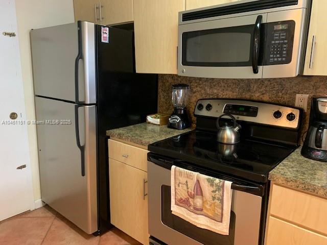 100 Lincoln Road, Unit 1129 Miami Beach, FL 33139 - Photo 6 of 31 a kitchen with stainless steel appliances granite countertop a refrigerator stove and microwave