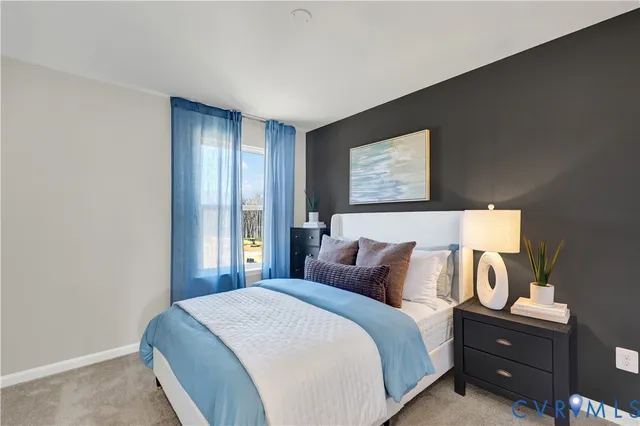 a bedroom with a bed and a painting on the wall