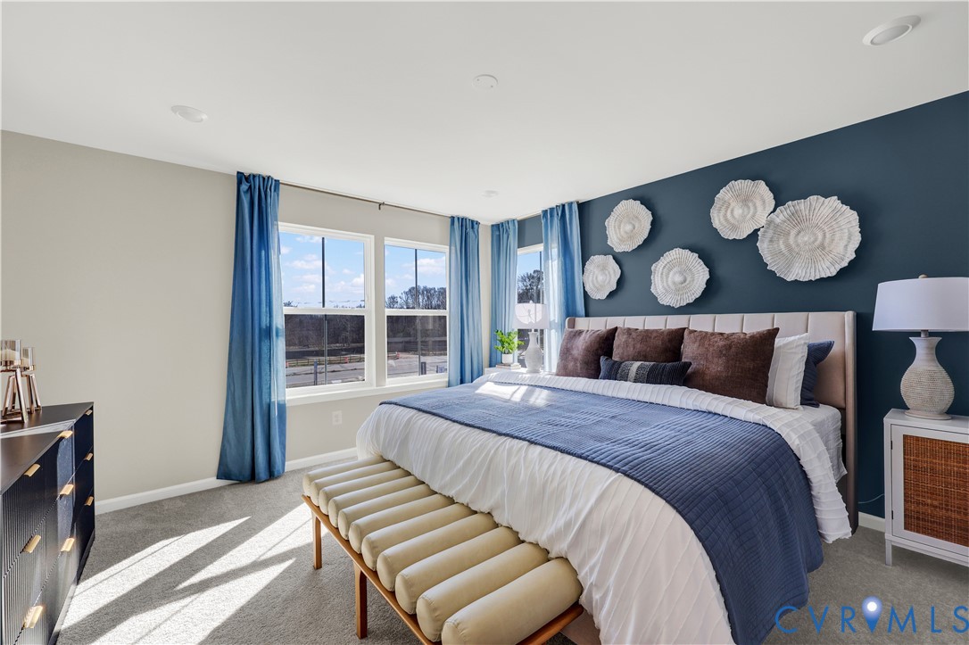 6033 Blue Iris Road Richmond, VA 23225 - Photo 17 of 27 a bedroom with a bed and wooden floor