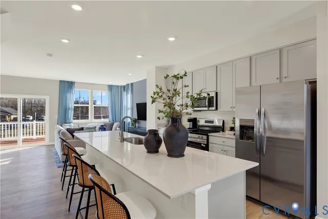 a kitchen with refrigerator and chairs