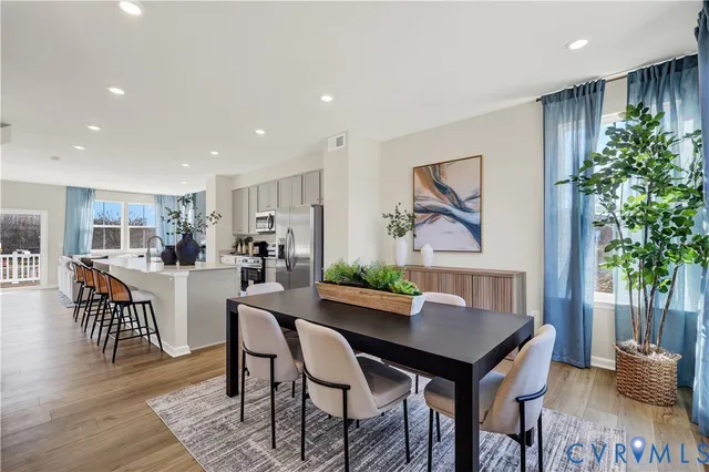 a view of a dining room with furniture and wooden floor