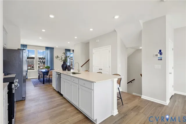 a open kitchen with stainless steel appliances granite countertop a lot of counter space and wooden floor