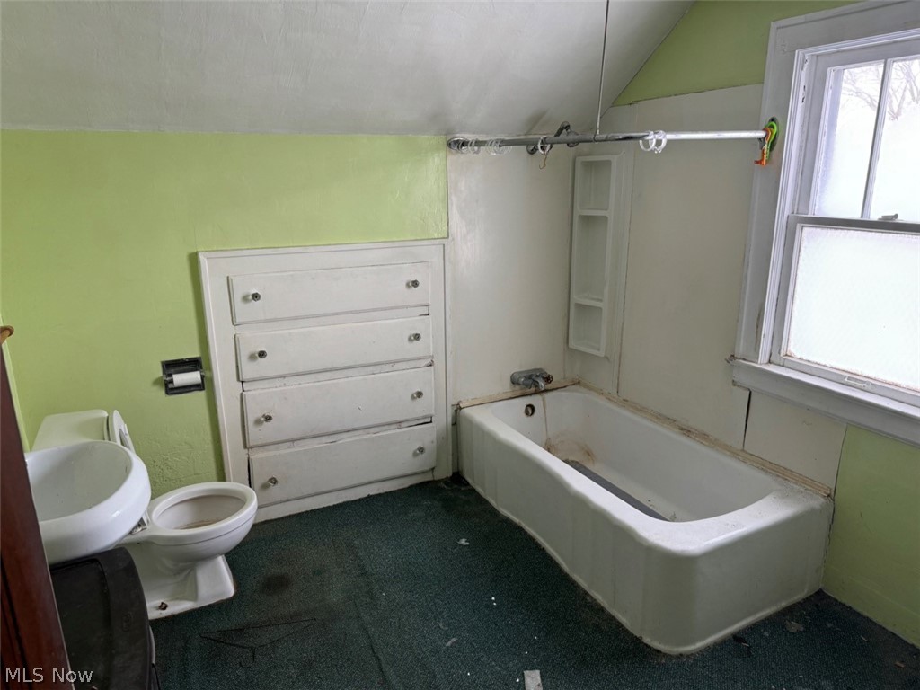 586 Brittain Road Akron, OH 44305 - Photo 11 of 19 Full bathroom featuring sink, vaulted ceiling, toilet, and tub / shower combination