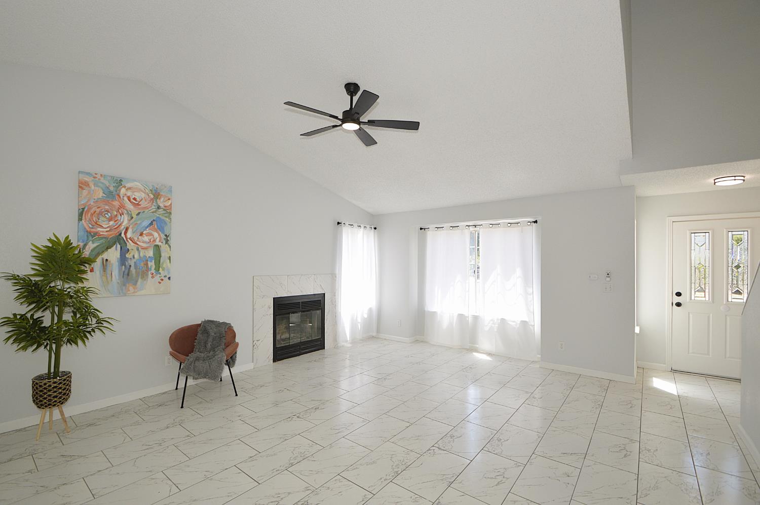 3290 North Rafael Avenue Fresno, CA 93722 - Photo 5 of 10 Tile flooring throughout down stairs. Vaulted ceilings, new ceiling fan