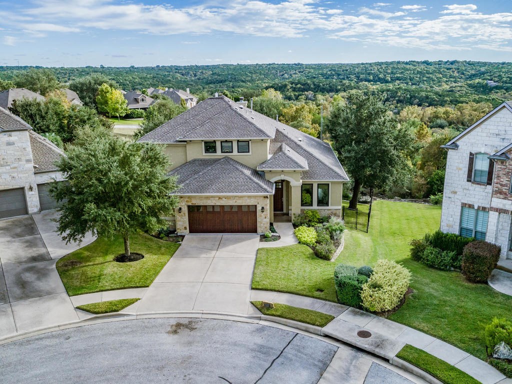 an aerial view of a house with yard
