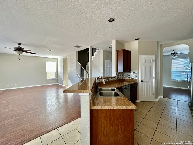 a kitchen with kitchen island granite countertop a stove and a sink