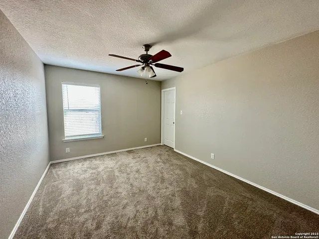 a view of room with a ceiling fan and window