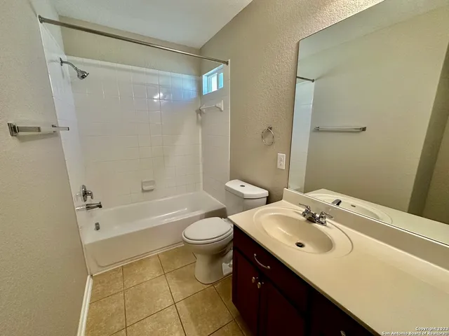 a bathroom with a sink mirror toilet and bathtub
