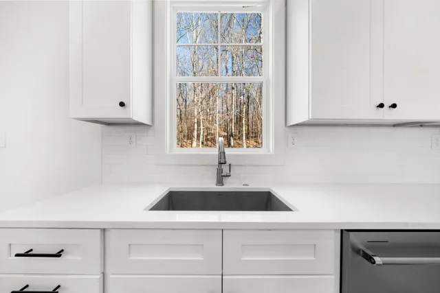 a kitchen with stainless steel appliances a refrigerator sink and stove
