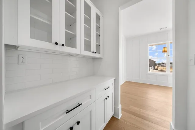 a view of a room with wooden floor windows and a ceiling fan