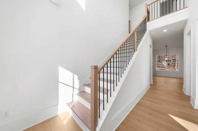 a view of a hallway with wooden floor and entryway