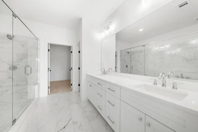 a bathroom with a bathtub and a glass door