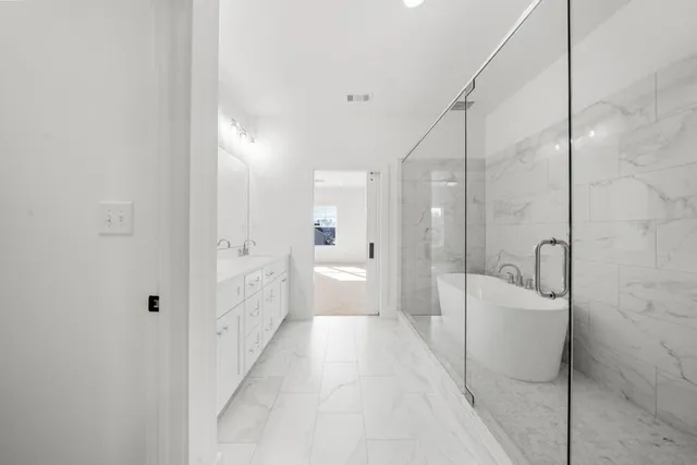 a bathroom with double vanity sink and a mirror