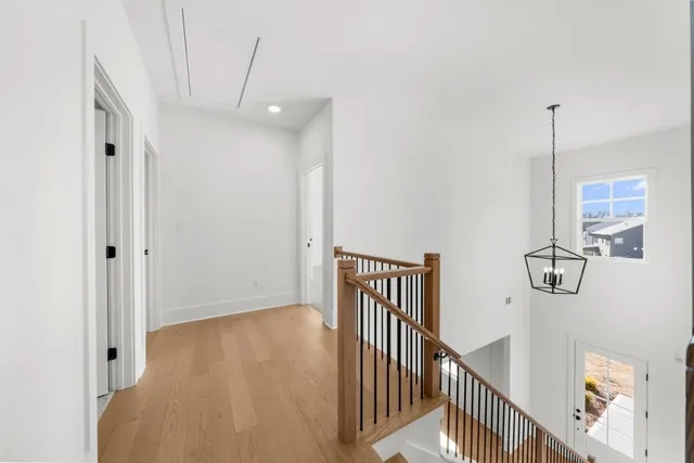 an empty room with a ceiling fan and window