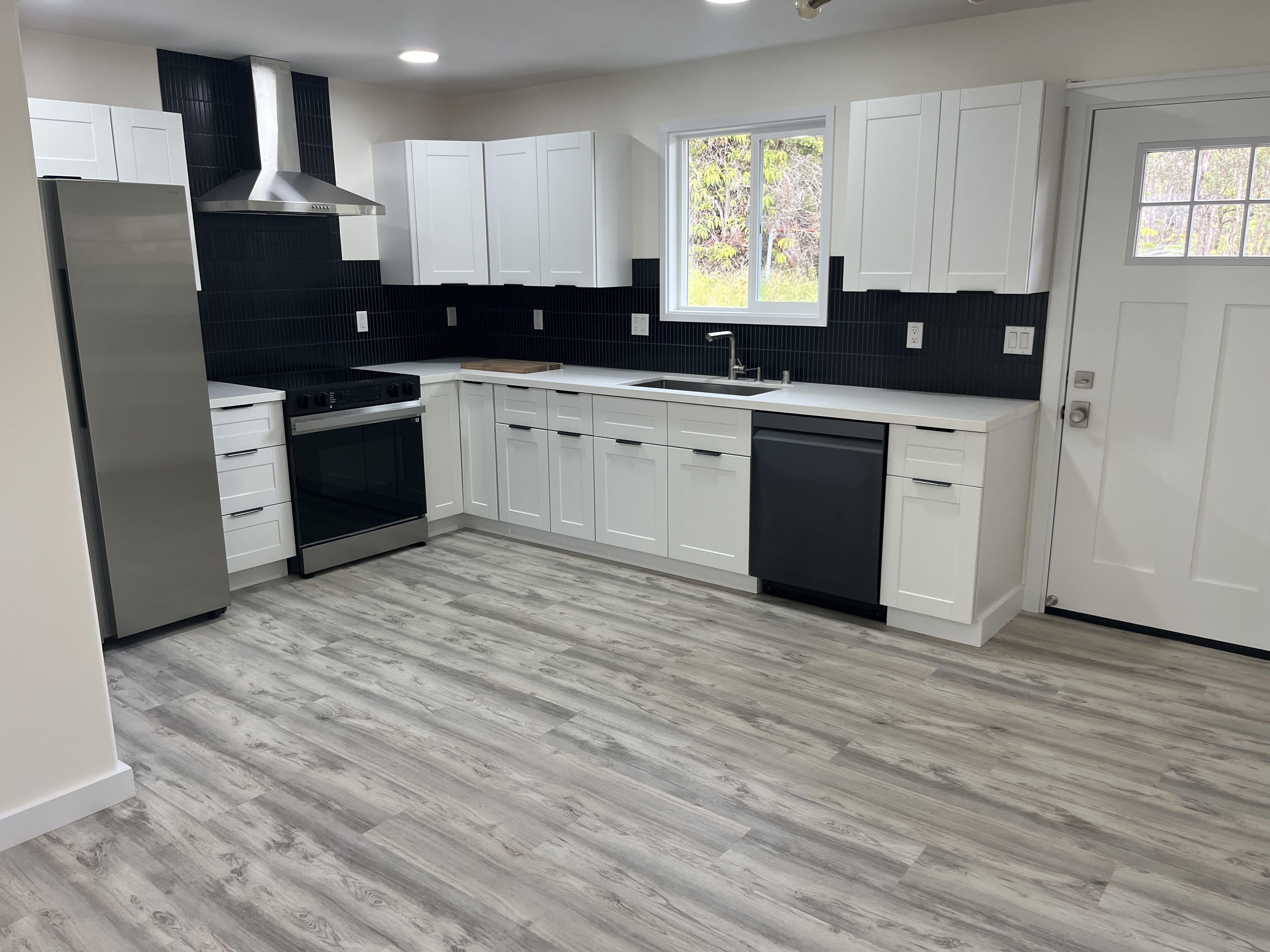 11-3234 Volcano Road Volcano, HI 96785 - Photo 3 of 23 a kitchen with granite countertop a sink cabinets and stainless steel appliances