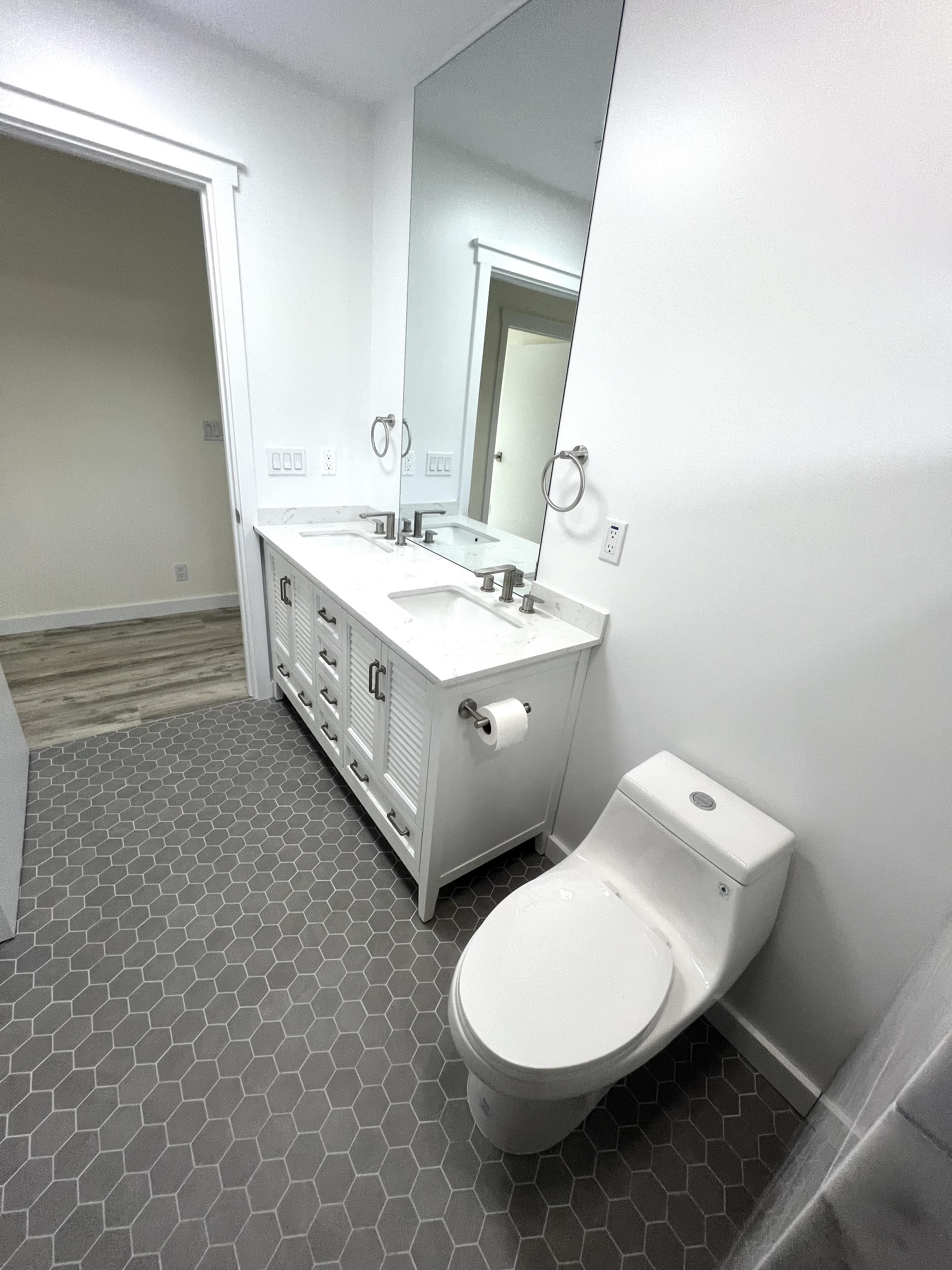11-3234 Volcano Road Volcano, HI 96785 - Photo 9 of 23 a spacious bathroom with a double vanity sink toilet and mirror