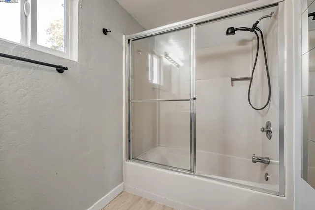 a bathroom that has a glass shower door