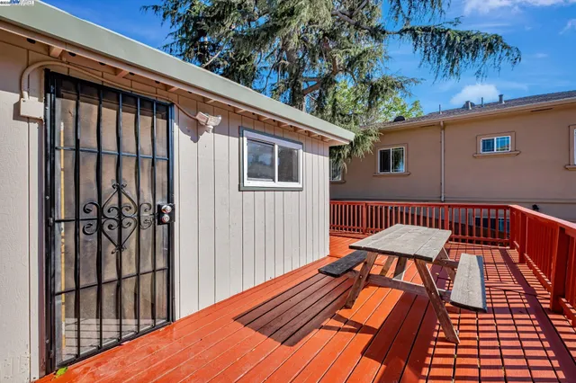 a view of a roof deck with wooden floor and fence