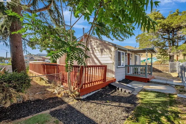 a small yard with trees in front of it