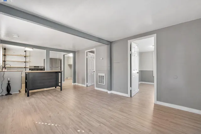 a view of a kitchen with a sink and a refrigerator
