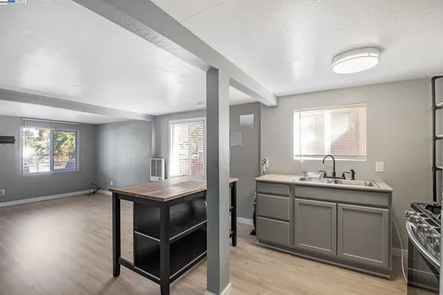 a room that has a sink window and wooden floor
