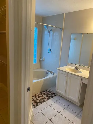 a bathroom with a bathtub and shower