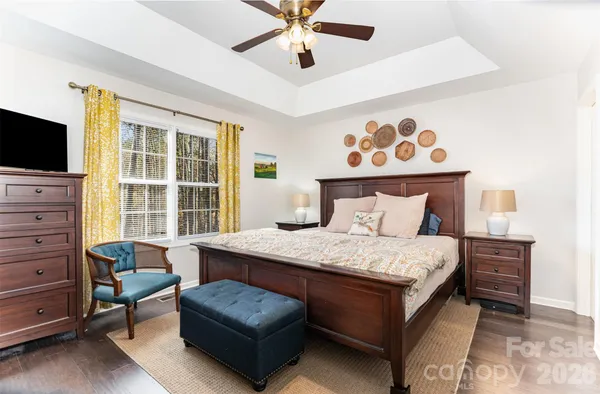 a bedroom with a bed and a television