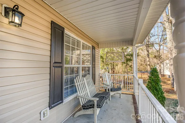 a view of a balcony with chair and wooden fence