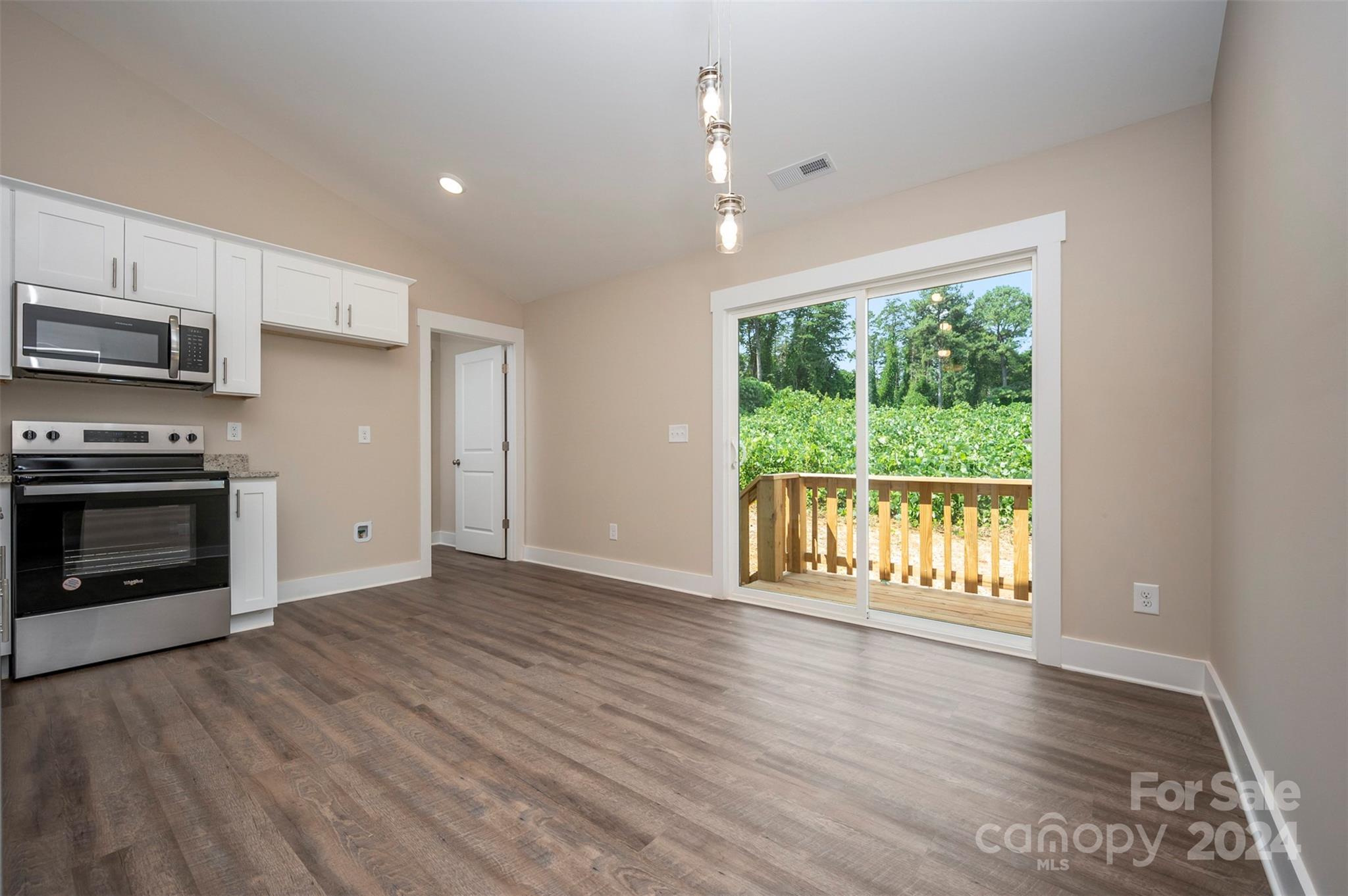 139 Forest Lake Road Forest City, NC 28043 - Photo 12 of 33 a view of an empty room with a window and wooden floor