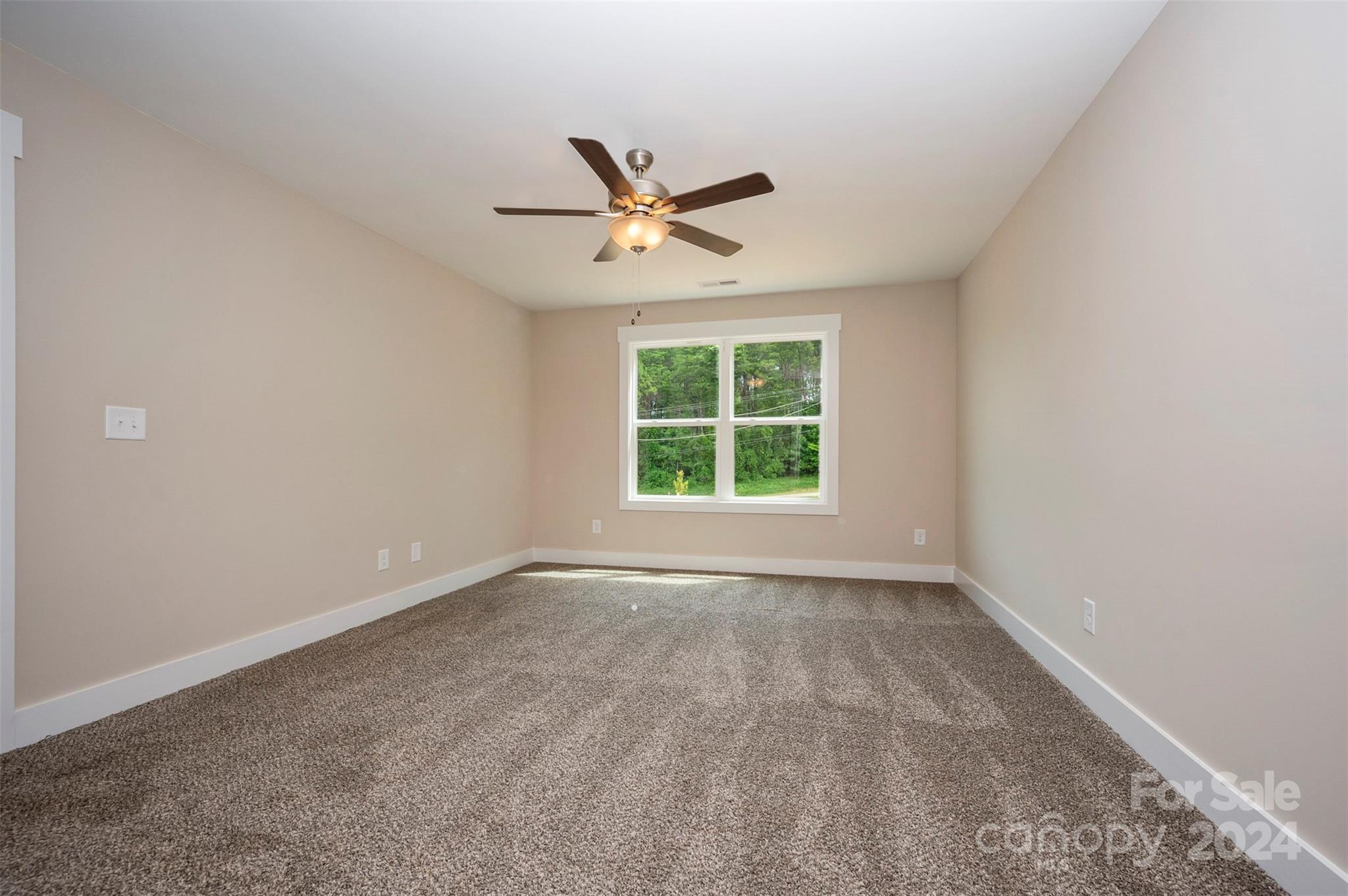 139 Forest Lake Road Forest City, NC 28043 - Photo 16 of 33 an empty room with a window and a fan