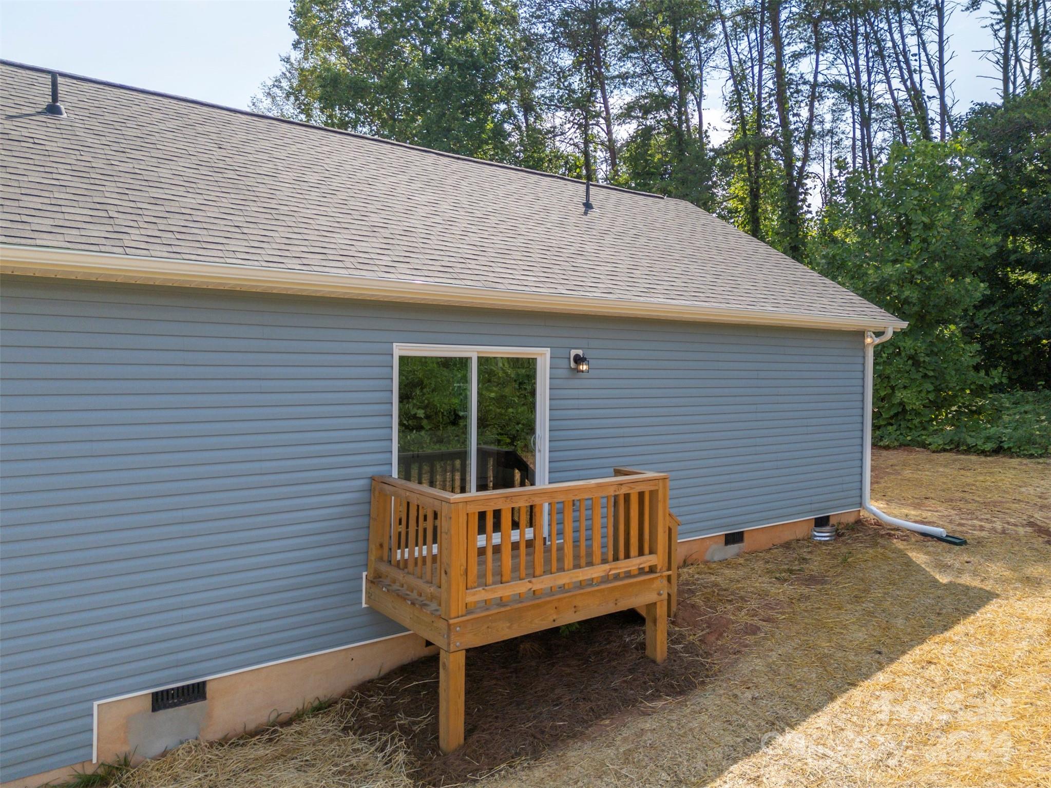 139 Forest Lake Road Forest City, NC 28043 - Photo 30 of 33 a view of a house with a wooden deck and a yard