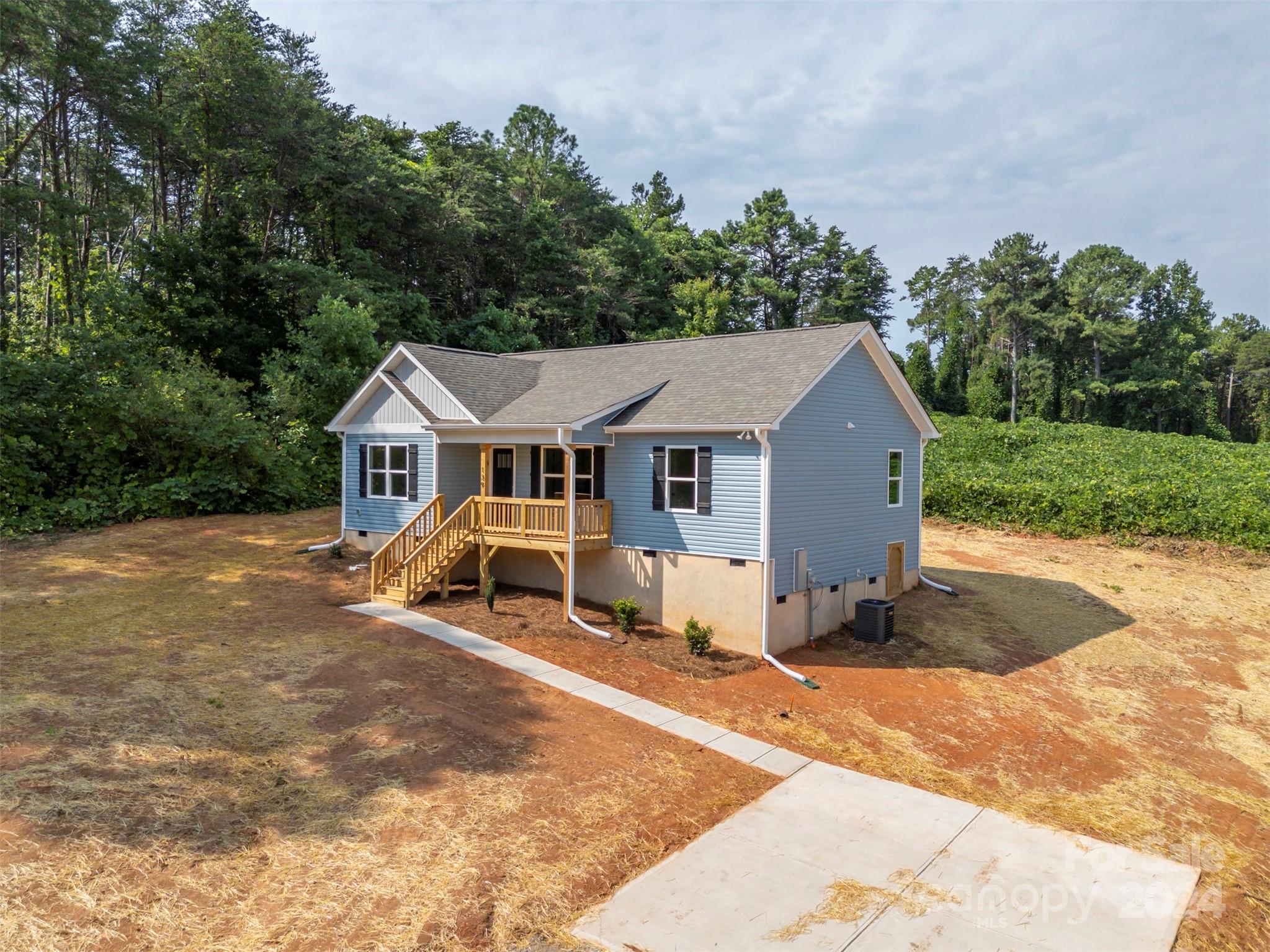 139 Forest Lake Road Forest City, NC 28043 - Photo 4 of 33 a view of a white house with a yard and large trees