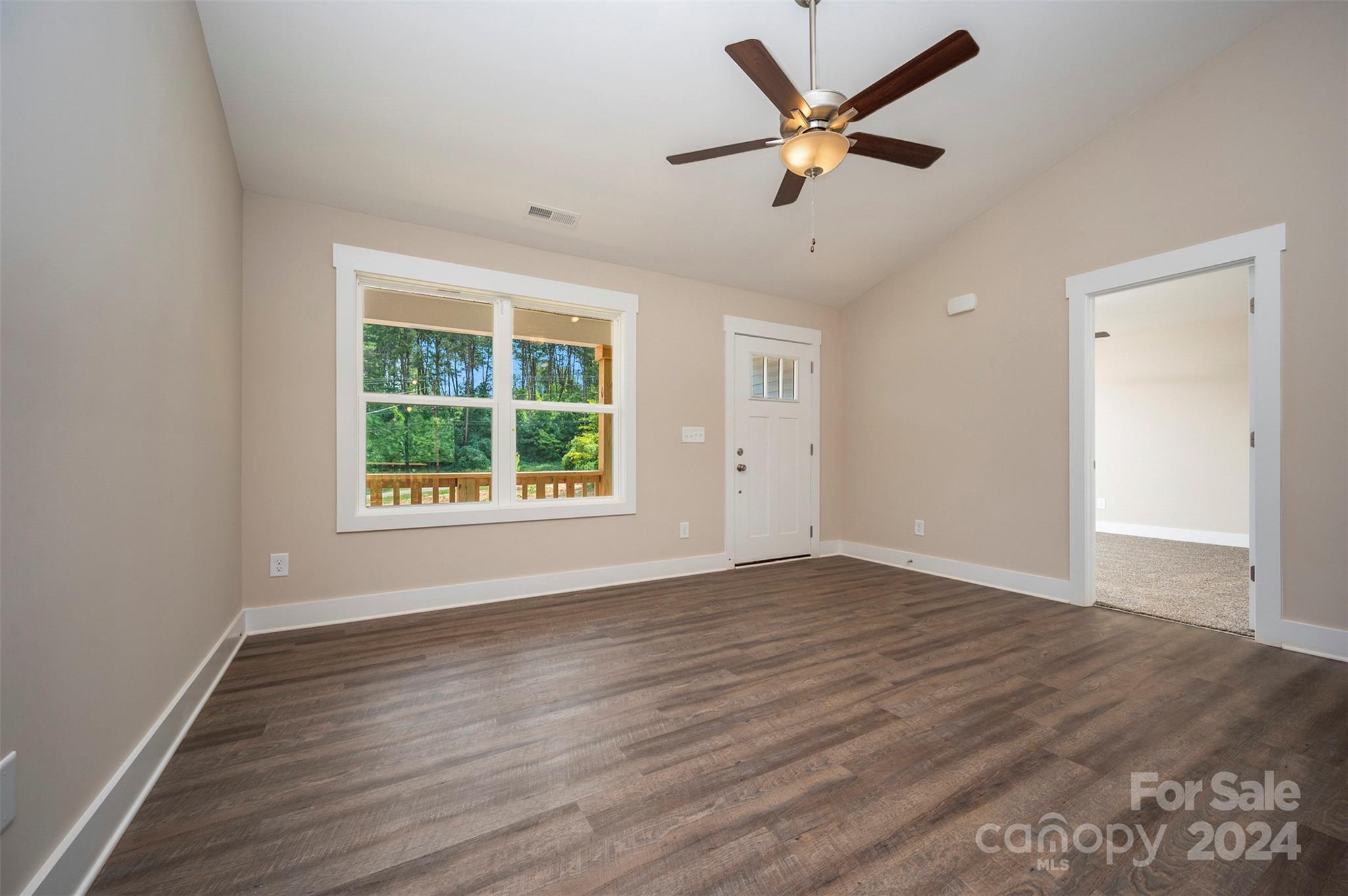 139 Forest Lake Road Forest City, NC 28043 - Photo 9 of 33 an empty room with wooden floor and windows