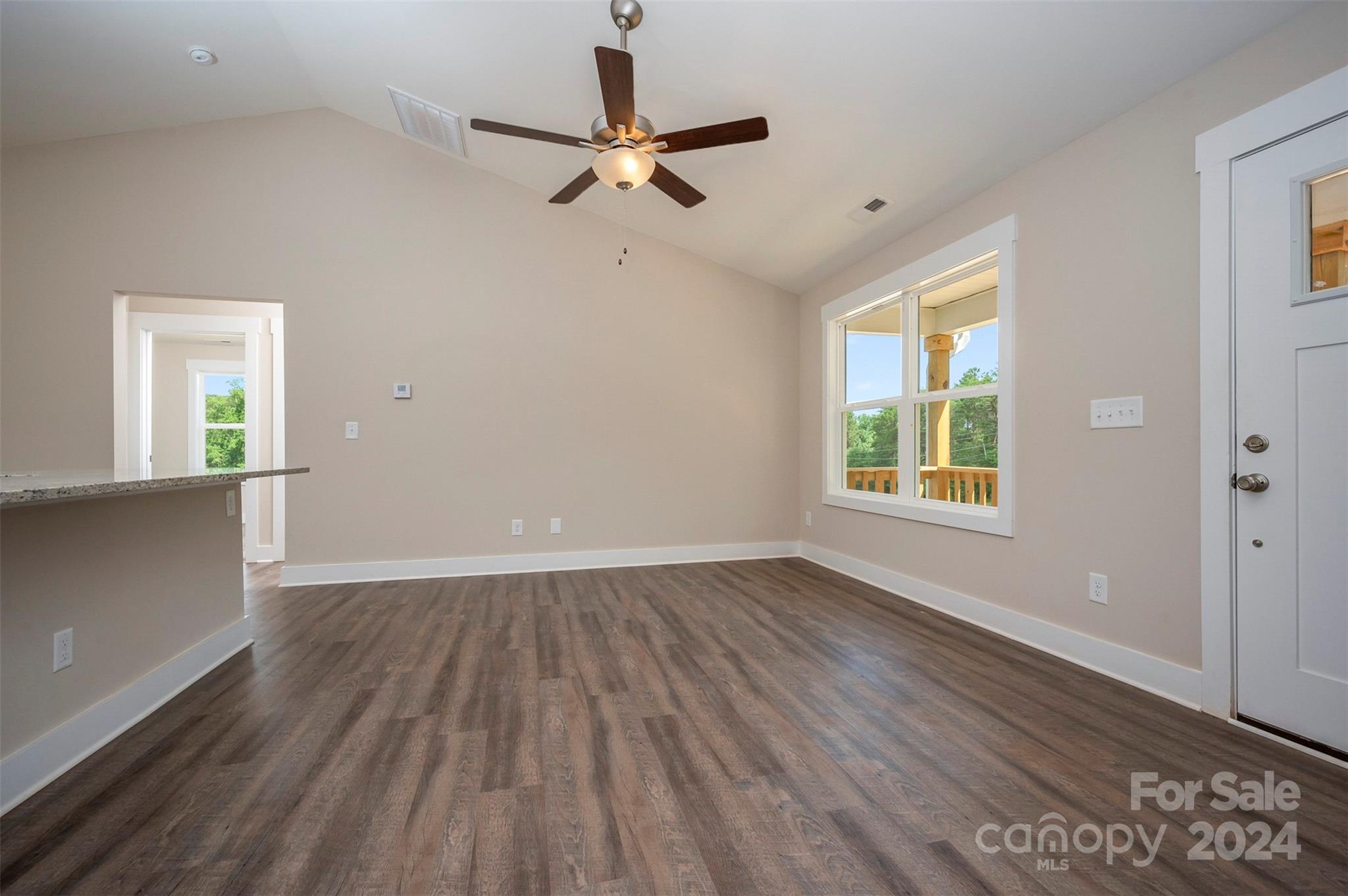 139 Forest Lake Road Forest City, NC 28043 - Photo 10 of 33 an empty room with wooden floor fan and windows