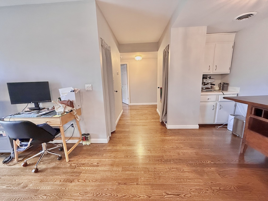 20 Stearns Road, Unit 45 Brookline, MA 02446 - Photo 8 of 22 a view of a workspace with furniture and a kitchen