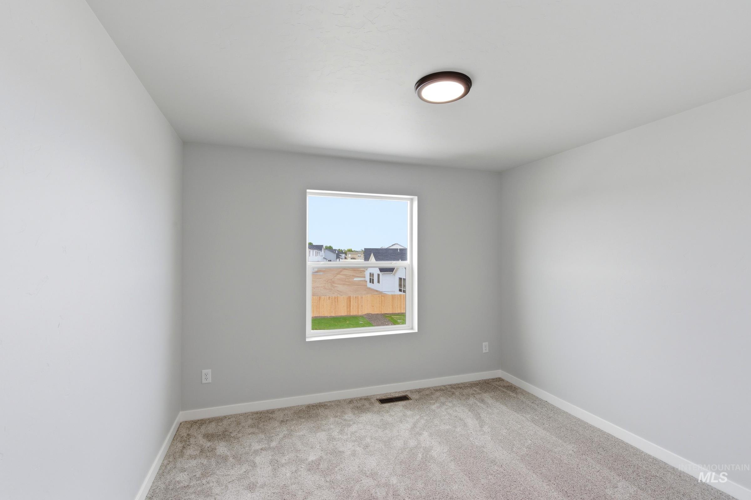 16558 Dunning Way Caldwell, ID 83607 - Photo 34 of 35 Room with light gray walls and plush gray carpet