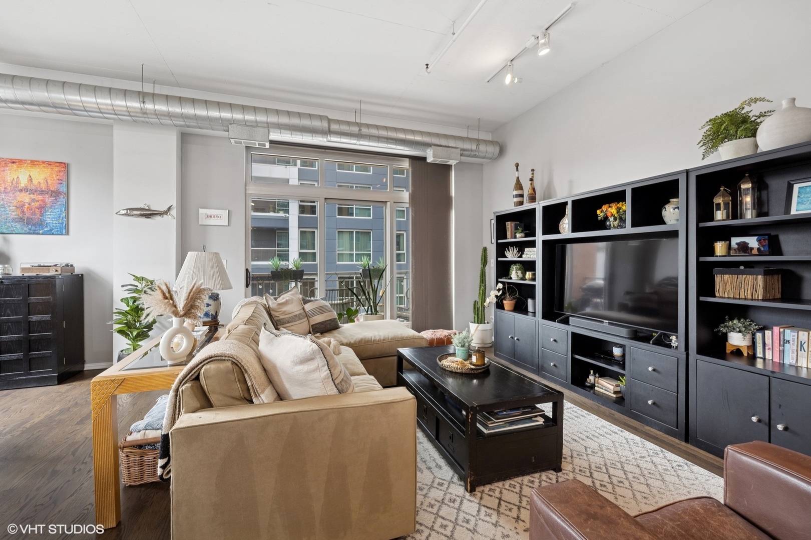 950 West Monroe Street, Unit 410 Chicago, IL 60607 - Photo 11 of 23 a living room with furniture and a flat screen tv