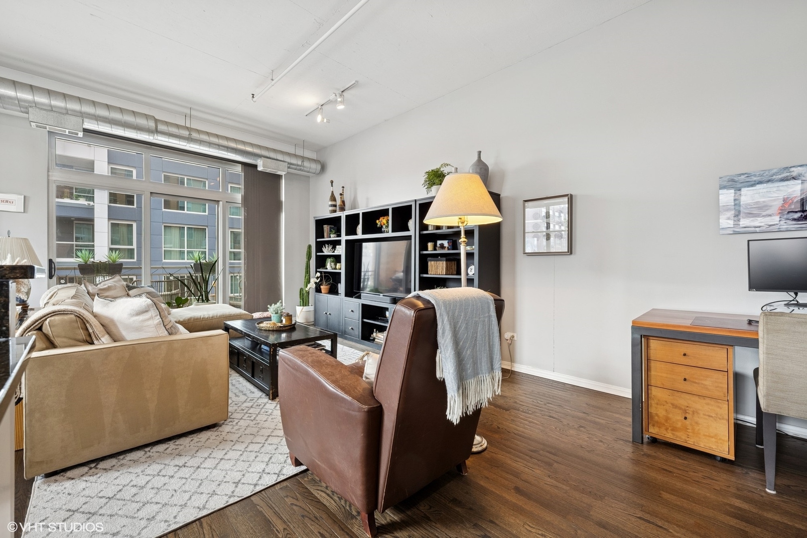 950 West Monroe Street, Unit 410 Chicago, IL 60607 - Photo 12 of 23 a living room with furniture and a wooden floor