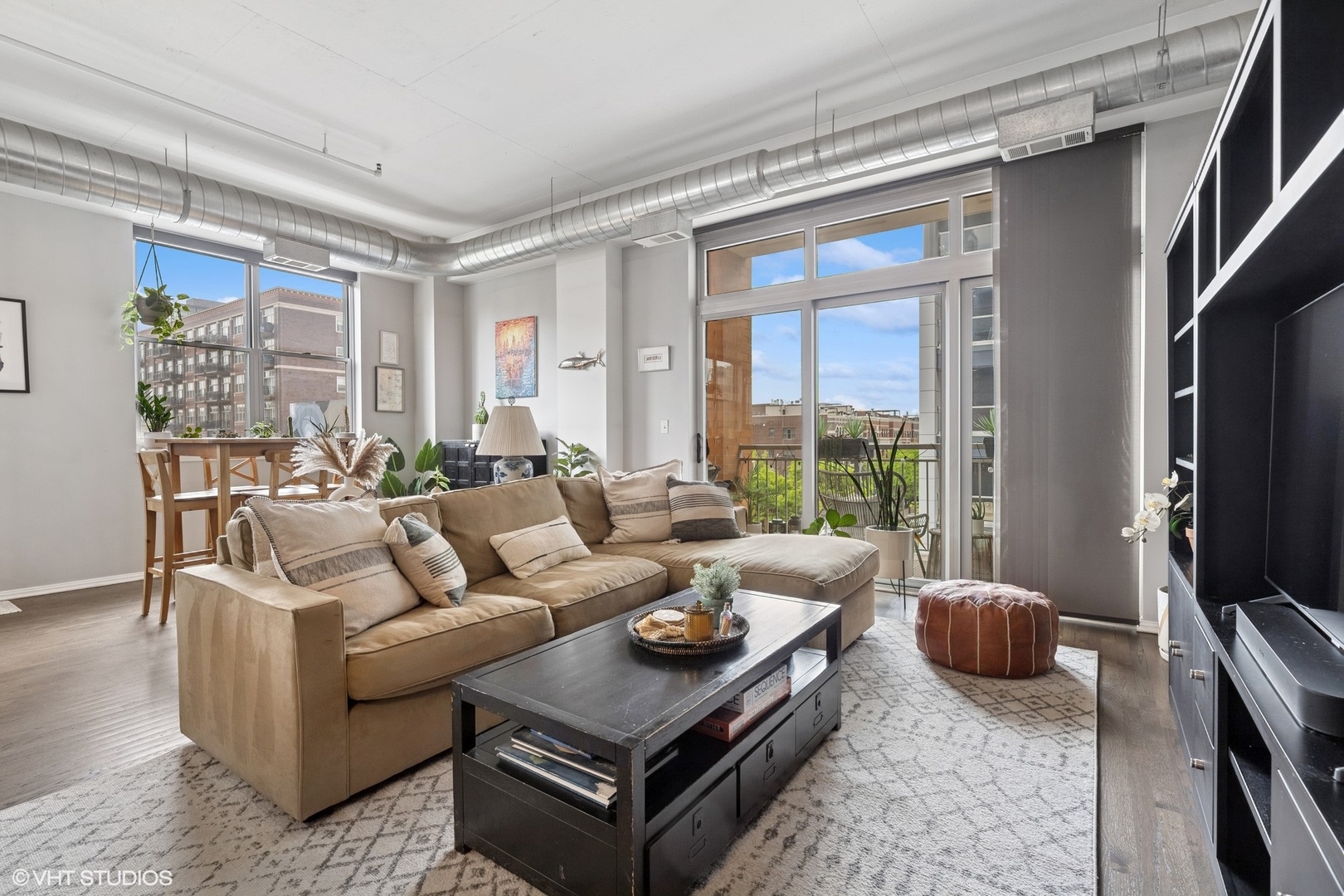 950 West Monroe Street, Unit 410 Chicago, IL 60607 - Photo 13 of 23 a living room with furniture a flat screen tv and a large window
