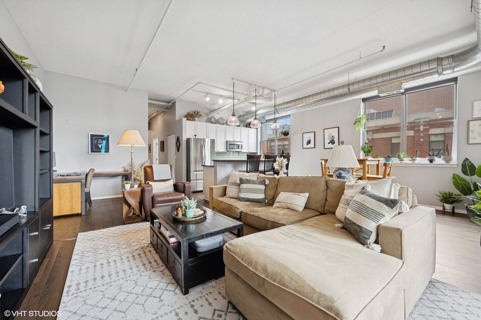 950 West Monroe Street, Unit 410 Chicago, IL 60607 - Photo 14 of 23 a living room with lots of furniture and a chandelier