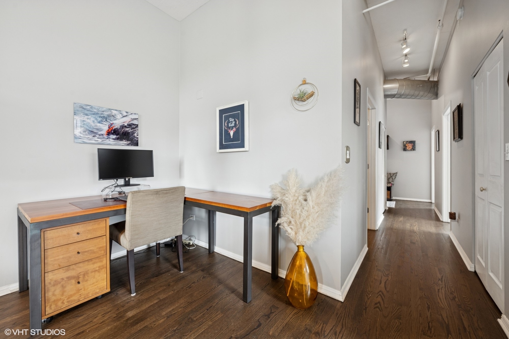 950 West Monroe Street, Unit 410 Chicago, IL 60607 - Photo 17 of 23 a view of a workspace with furniture and wooden floor